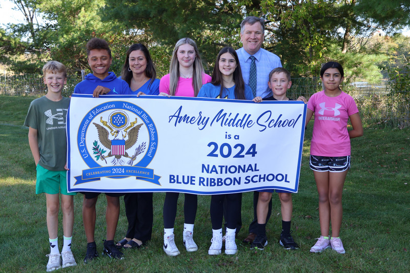 Middle School students and staff with the 2024 National Blue Ribbon School banner