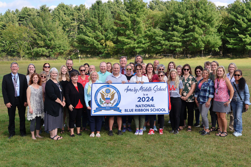 Middle School staff with the 2024 National Blue Ribbon School banner